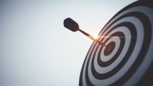 seven business goals for deriving from data blog feature image. Image of a bullseye with an arrow in the center
