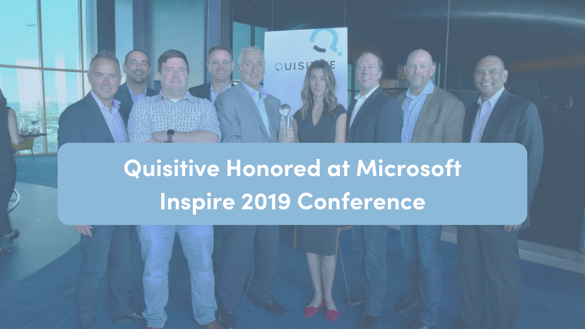 Several people in corporate dress standing around a crystal award with text Quisitive Honored at Microsoft Inspire 2019 Conference