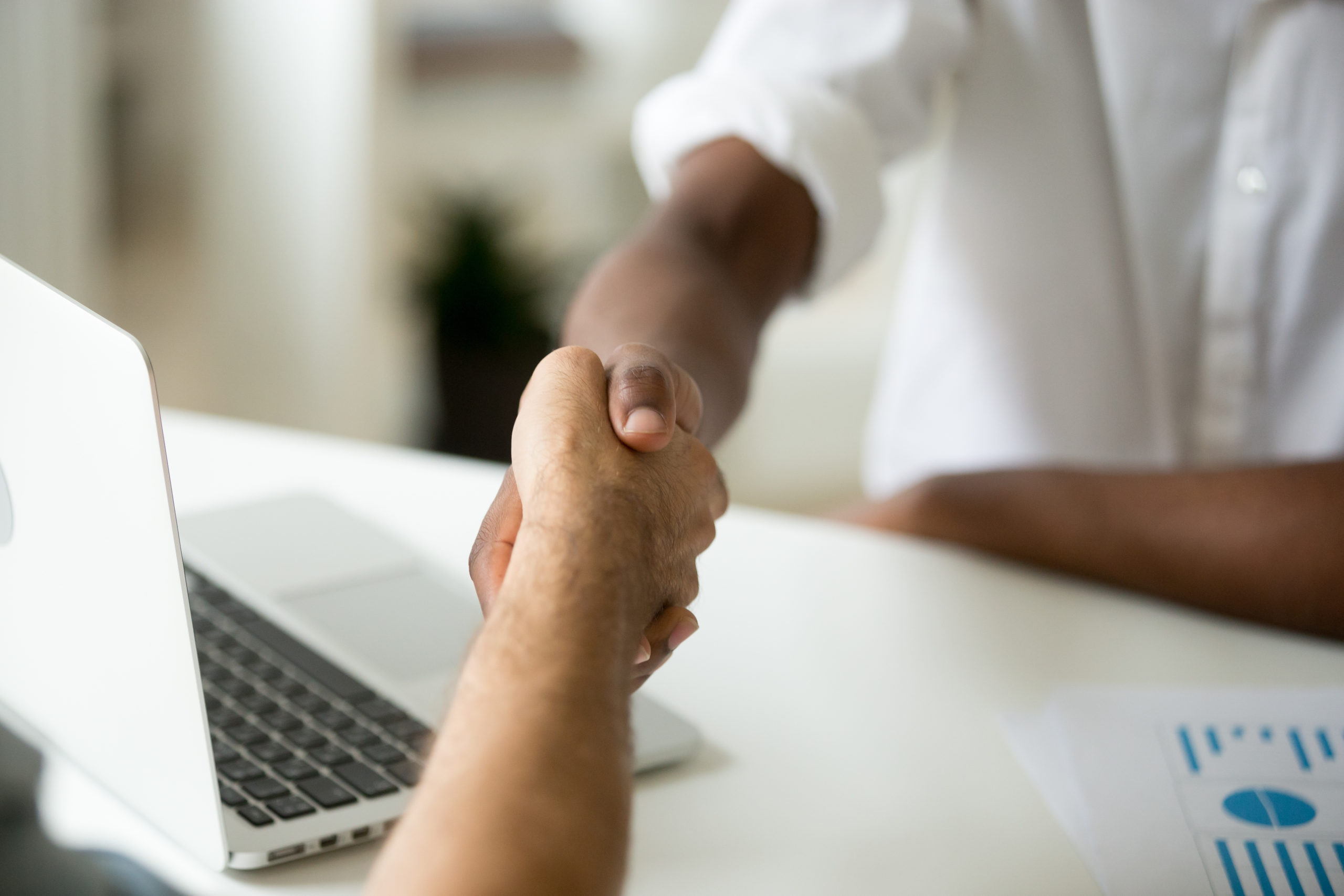 Two people shake hands as they enter a business agreement. This represents the partnership between organization’s looking to undergo a cloud migration and the cloud services partner they choose to help them take on the task.