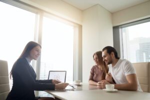 An insurance professional sits down with her customers, represents how breaking down silos via the cloud can provide better experiences