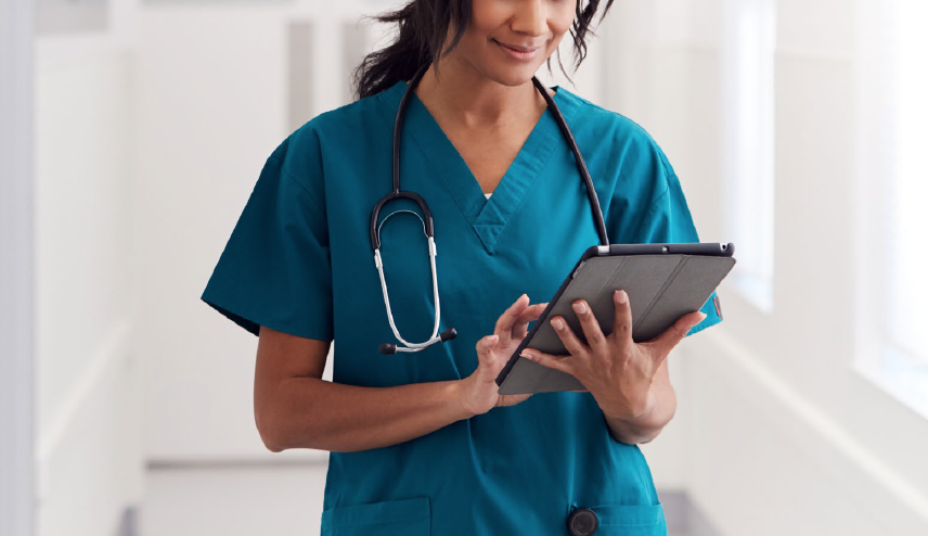 Disaster Recovery in Azure Cloud for Non-profit Hospital Case Study Feature Image - A female doctor in scrubs and wearing a stethoscope walks through the halls of a hospital with a clipboard in hand.