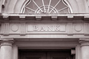 Image of the front of a bank building. Learn more about Trends in banking in 2022 with part 2 of our blog series.