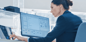 Spyglass Closes Security Gaps for Architecture & Engineering Firm Feature Image: A woman works at her computer and on a tablet