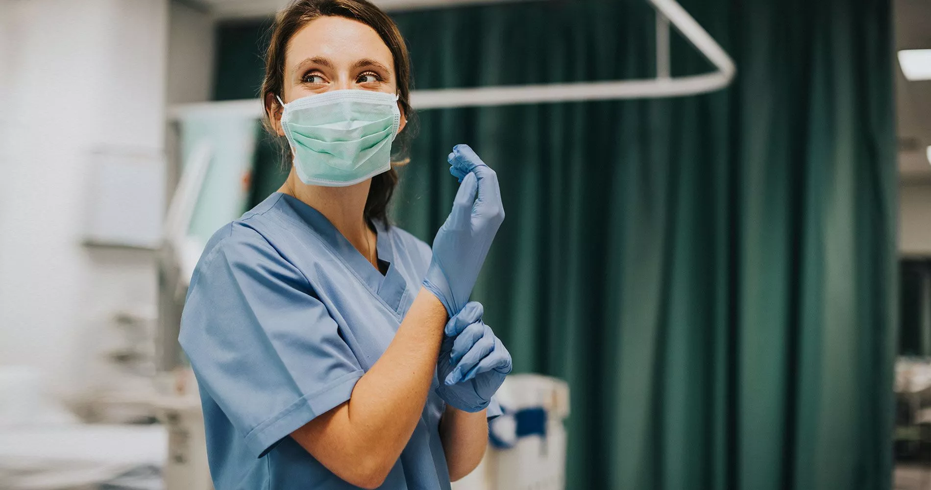 female nurse puts on her gloves - case study image, american nurses association