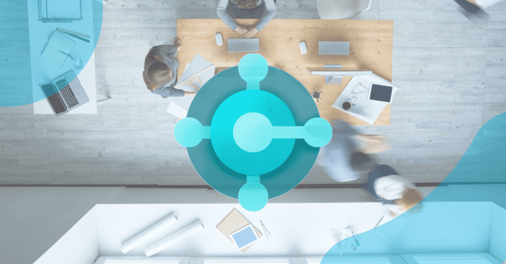 Business Central 2023 Wave 1 Updates Feature Image: People in office from overhead with the Business Central logo overlaid