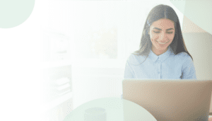 No Code / Low Code Application Modernization on Azure and Power Apps Header Image: A woman works happily on her computer in her office