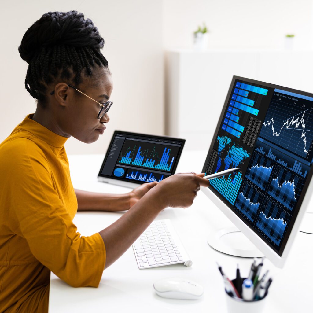 African American Business Data Analyst Woman Using Computer - Data Management Services to help unlock powerful insights