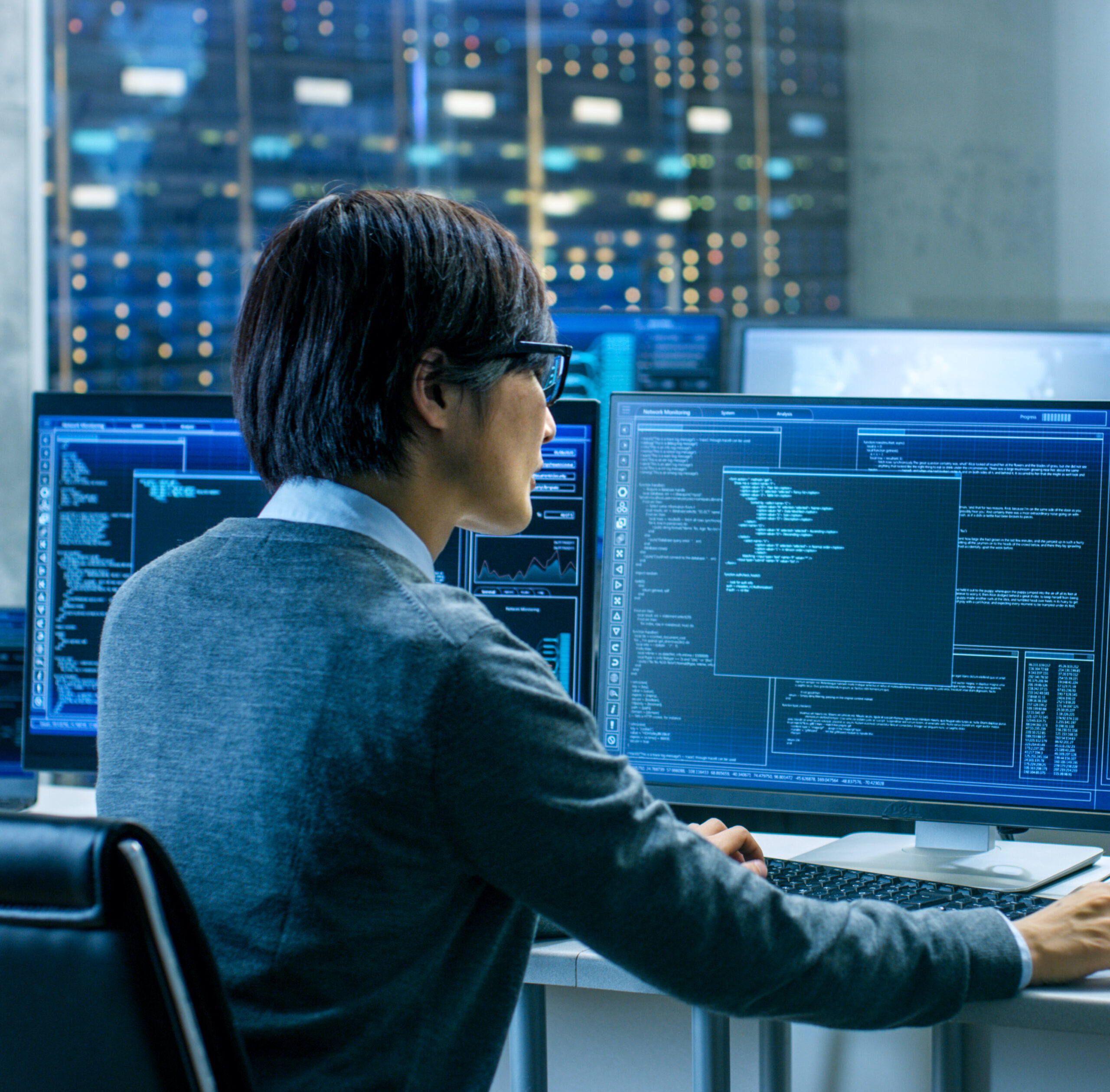 A man sits at a computer, reviewing data models and security reports for a client. Managed Detection and Response capabilities allow him to catch threats early so clients can react swiftly