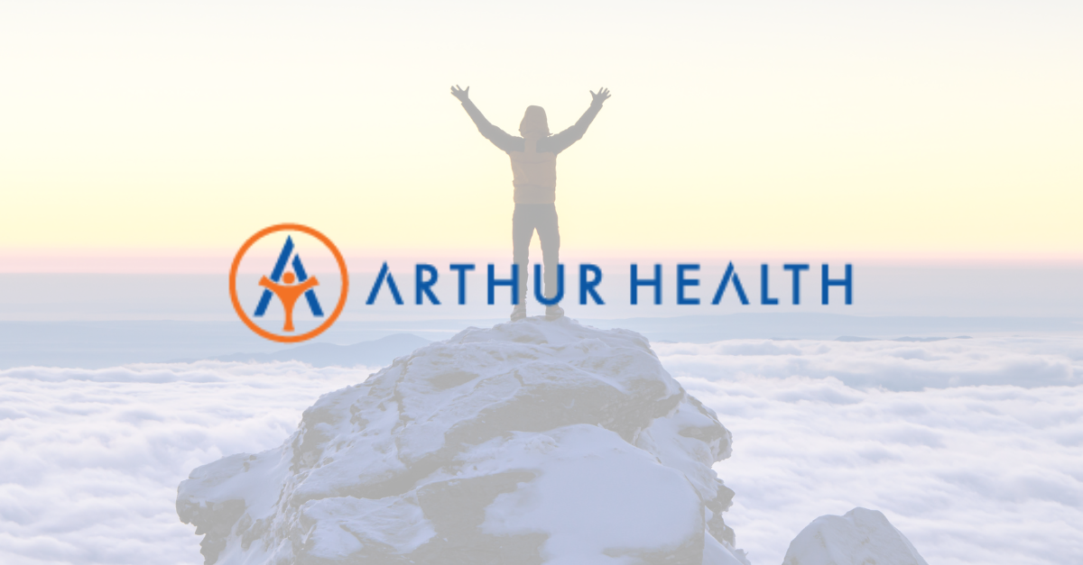 Photo of a person standing on a mountain top with the Arthur Health logo overlaid