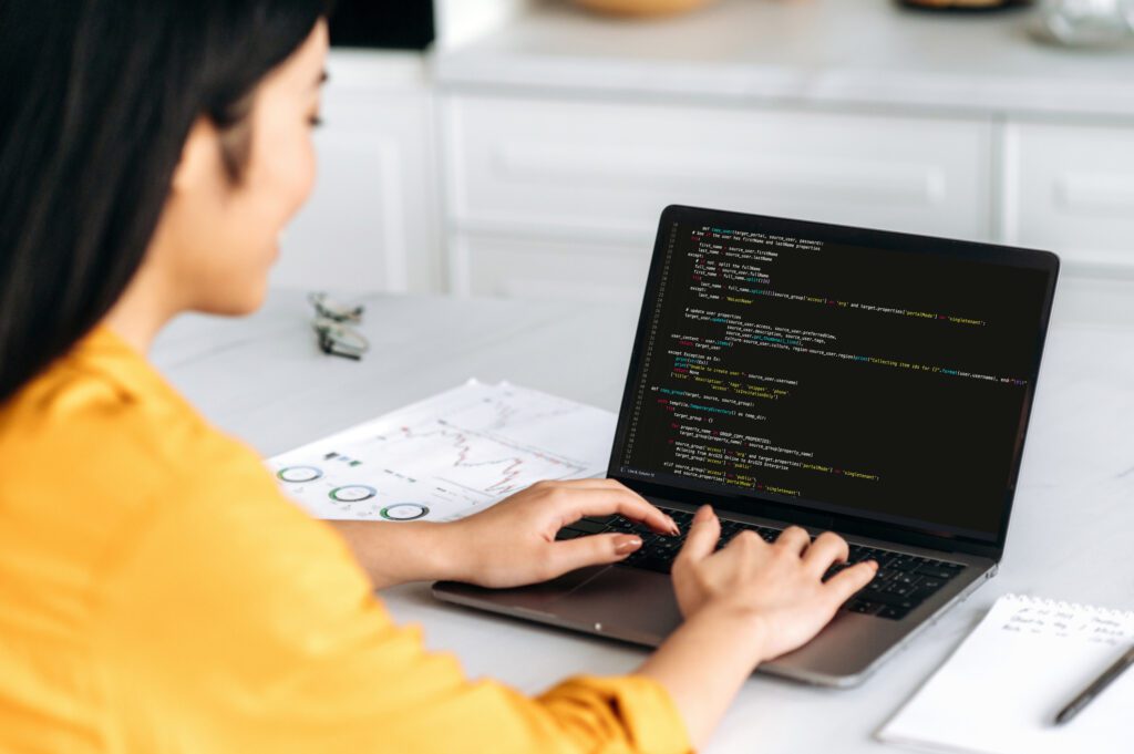 woman running scripts on a laptop.