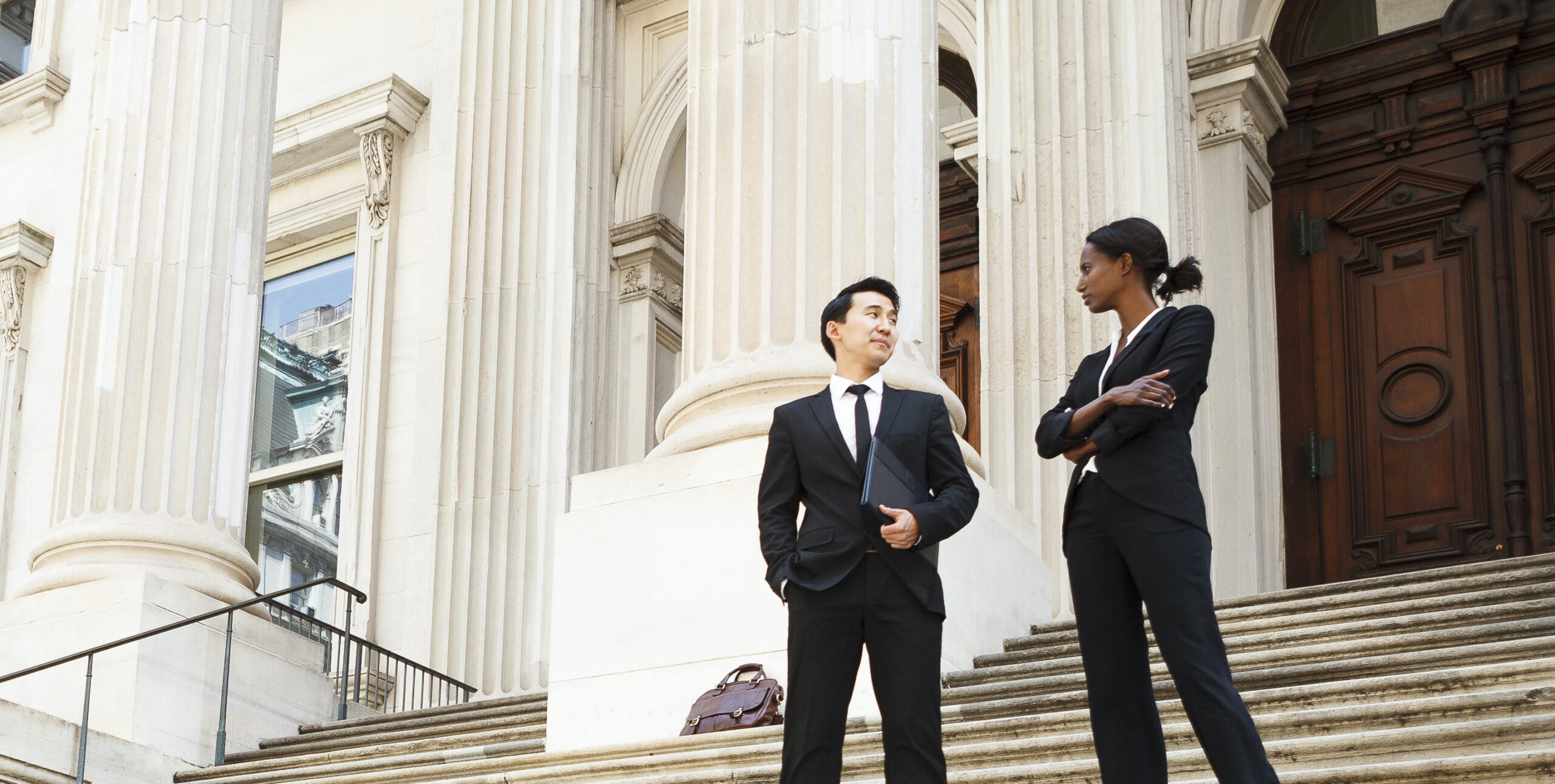 Must-Have Tools to Fortify Your Security Event Feature Image - 2 people stand on the steps of a government building