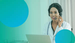 Blog Feature Image 5 Ways a Digital Contact Center for Healthcare Can Transform Your Healthcare Practice: A black woman in a doctors coat talking on a headset and sitting at a laptop while on a call with a patient