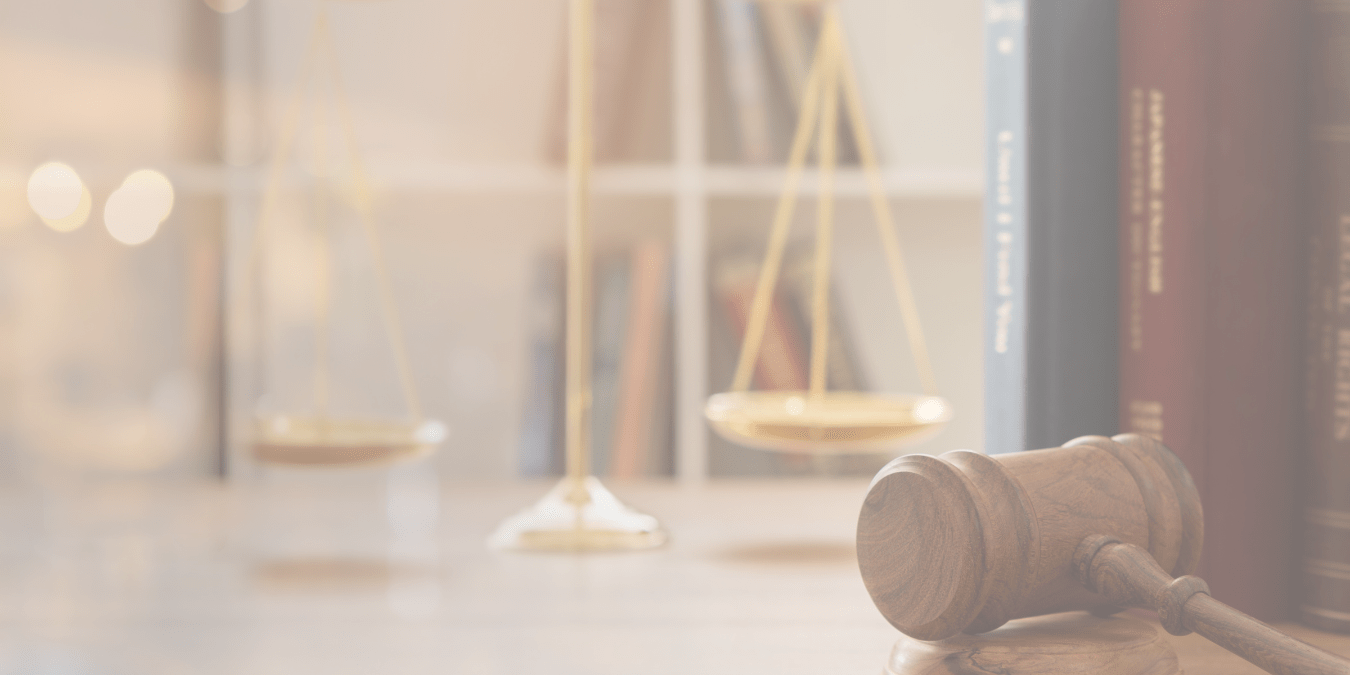 Event Feature Image Leveraging AI to Transform Legislative Research Management - a desk in a law office or court room with scales of justice sitting on top