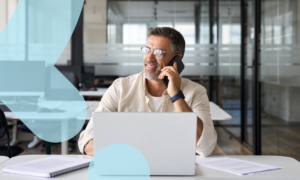 A man sits in the office and chats with his Dynamics consultants about Dynamics 365 Pricing