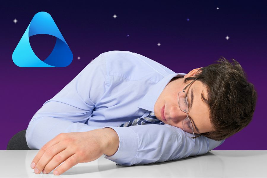 Blog Feature Image: How Microsoft Purview Helps in the Age of AI and Data Chaos - a man asleep at his desk and dreaming of Microsoft Purview